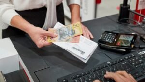 banconote e monete accanto a carta conto poste