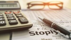 calcolatrice e documenti finanziari accanto a occhiali