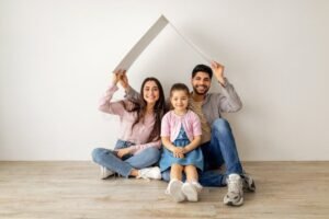 famiglia felice sotto una casa protettiva